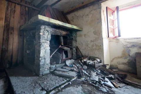 Collapsed fireplace in abandoned mountain barracks, France — Nicolas Marincic