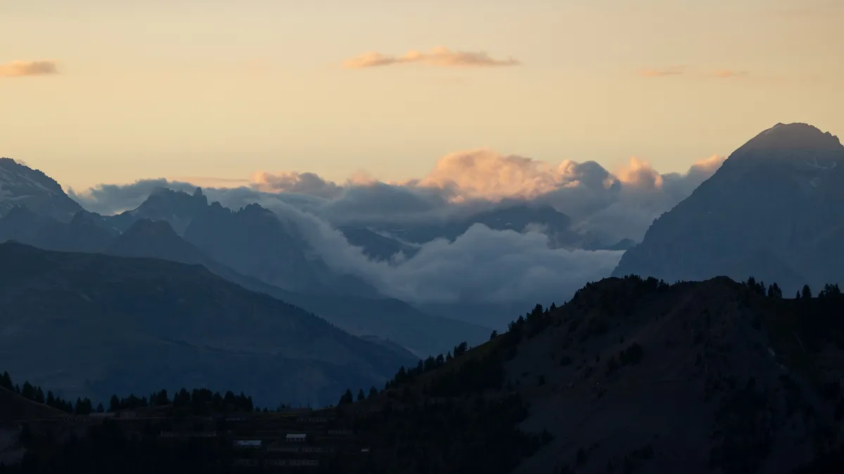Dusk clouds settling between mountain ranges — Nicolas Marincic