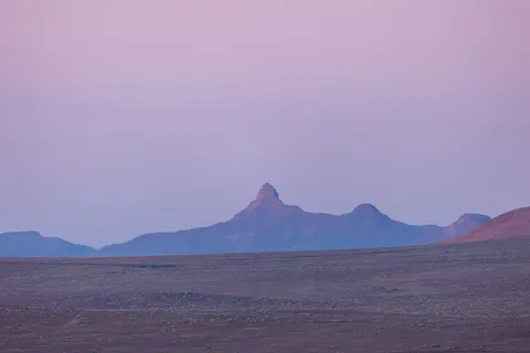 Pink dawn over a lone peak, Fish River Canyon plateau, Namibia — Nicolas Marincic