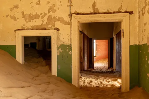 Enfilade of sand-filled doorways, Kolmanskop, Namibia — Nicolas Marincic