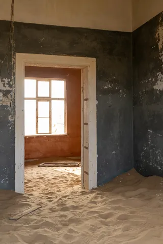 Blue and red rooms through a doorway, Kolmanskop, Namibia — Nicolas Marincic