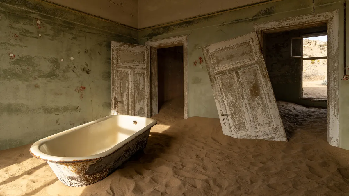 Bathtub and leaning door in the sand, Kolmanskop, Namibia — Nicolas Marincic