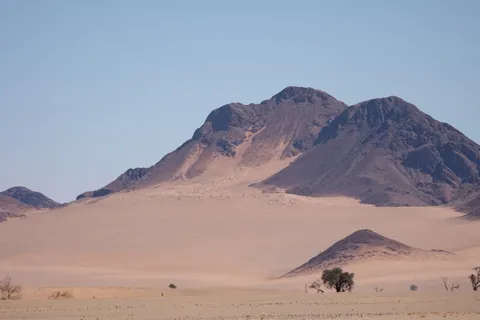 Pink sand ramps against dark peaks, Namib, Namibia — Nicolas Marincic