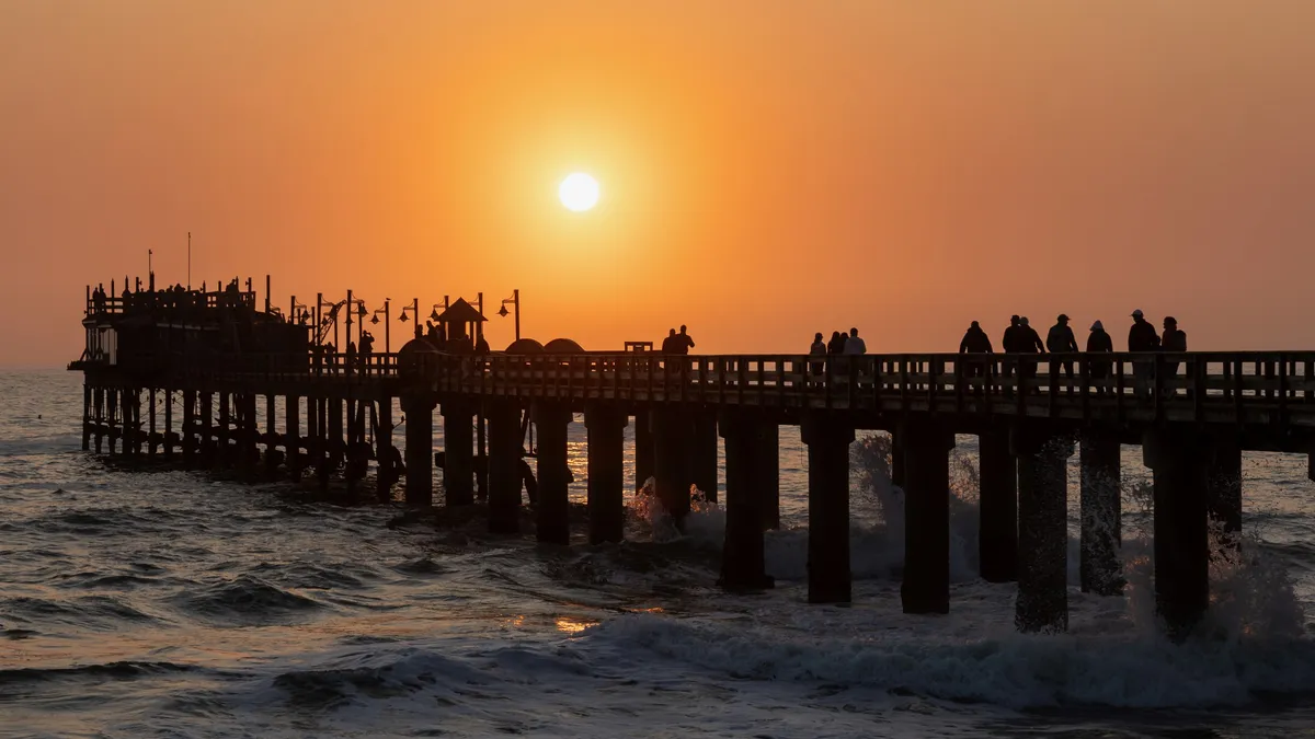 Swakopmund jetty silhouetted at sunset, Namibia — Nicolas Marincic