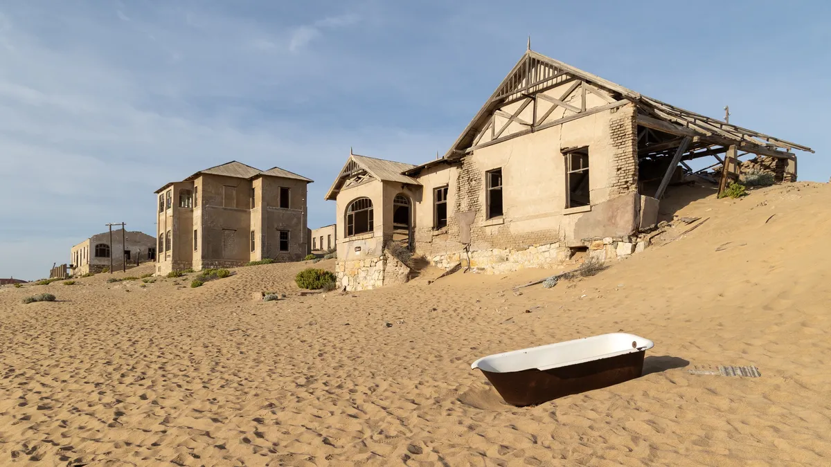 Sand-filled houses and bathtub at Kolmanskop, Namibia — Nicolas Marincic