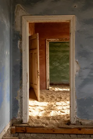Sand-filled doorways at Kolmanskop, Namibia — Nicolas Marincic