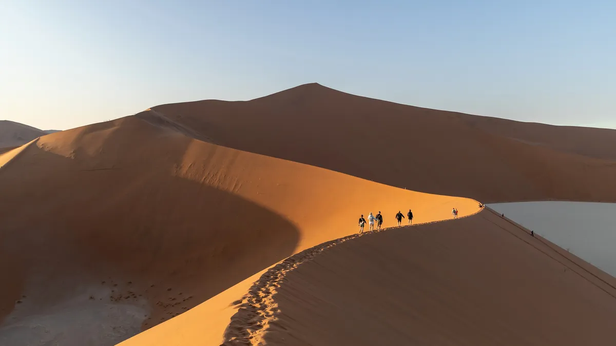Walkers on a ridge above Deadvlei, Namibia — Nicolas Marincic