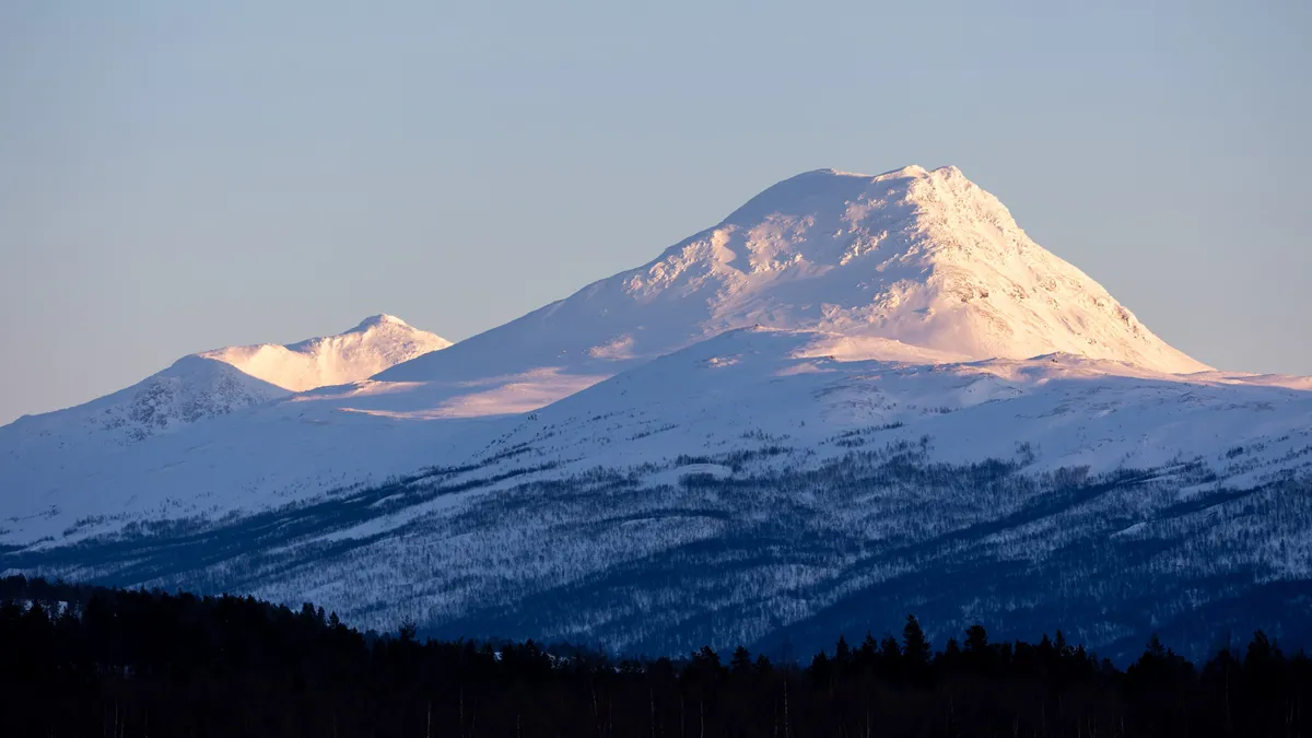Alpenglow on a snowy peak, Troms, Norway — Nicolas Marincic