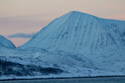 Snowy pyramid peak at pastel dusk, Troms, Norway — Nicolas Marincic