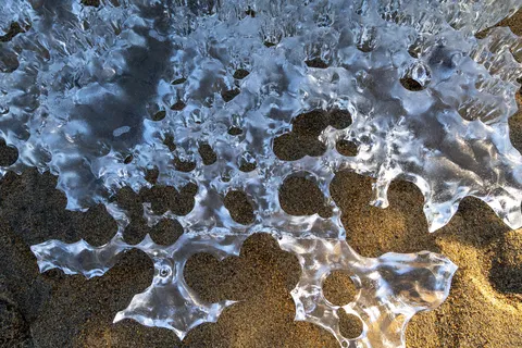 Ice lace over sand on an Arctic beach, Norway — Nicolas Marincic
