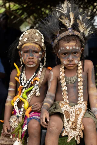 Children adorned with shells and feathers, Papua — Nicolas Marincic
