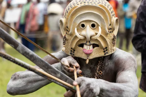 Archer wearing a carved mask, Papua — Nicolas Marincic