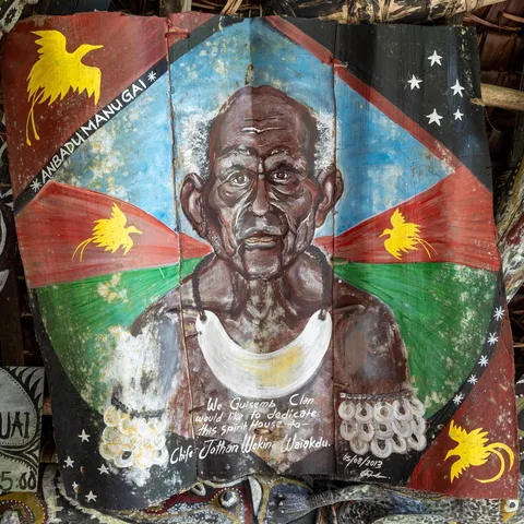 Painted bark portrait of an elder with flags, haus tambaran, Papua — Nicolas Marincic