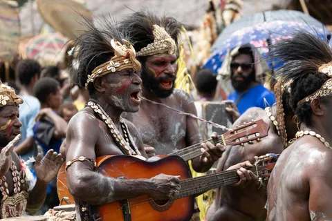 String band singers adorned with feathers, Papua — Nicolas Marincic