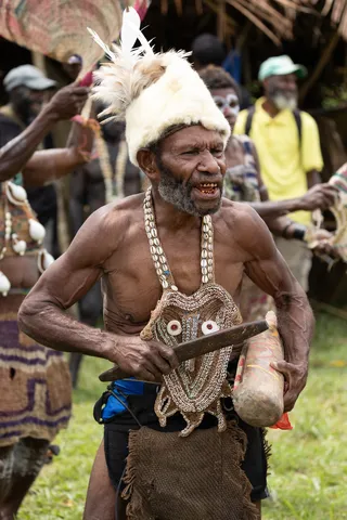 Elder dancer with shell bib and drum, Papua — Nicolas Marincic