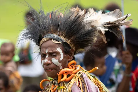 Woman in a black feather crown, Papua — Nicolas Marincic
