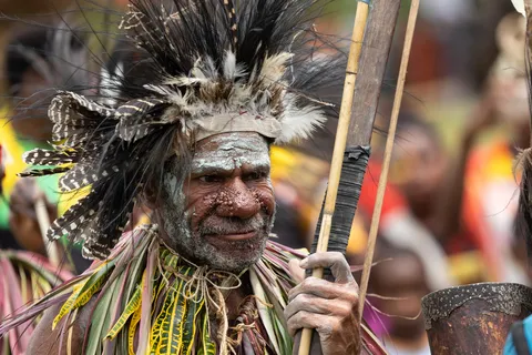 Elder warrior with bow and feathers, Papua — Nicolas Marincic