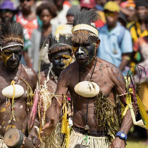 Black and yellow painted warriors with ovulum shells, Papua — Nicolas Marincic