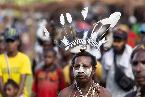 White-painted face and feather crown, Papua — Nicolas Marincic