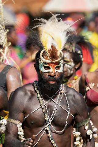Warrior with bird-of-paradise crest and shell straps, Papua — Nicolas Marincic
