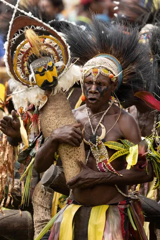 Elder with drum and woven mask, Papua — Nicolas Marincic