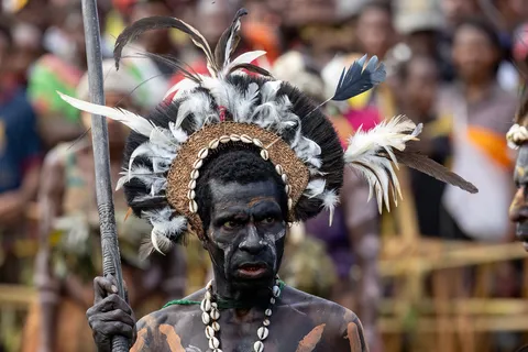 Black-painted warrior with a feather halo, Papua — Nicolas Marincic