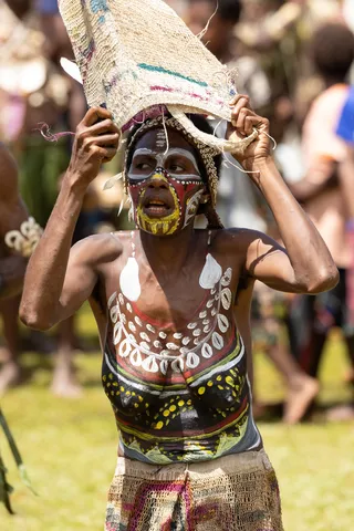 Woman with painted body and basket, Papua — Nicolas Marincic