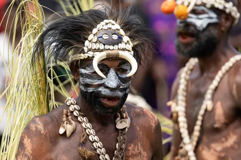Black and white face under a cowrie headdress, Papua — Nicolas Marincic