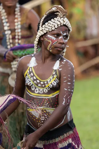 Young woman with cowrie headdress and body paint, Papua — Nicolas Marincic