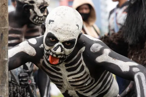 Chimbu skeleton dancer sticking out his tongue, Papua — Nicolas Marincic