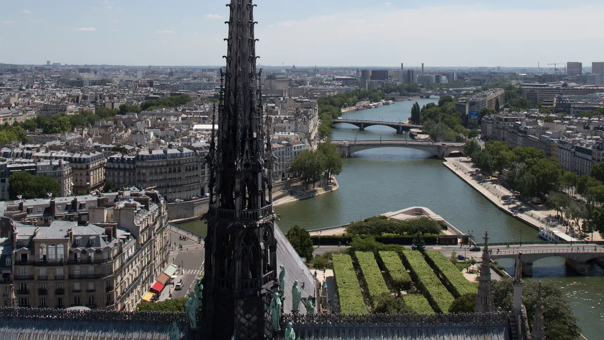Notre-Dame spire over the Seine and Île Saint-Louis, France — Nicolas Marincic