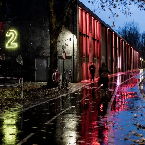 Neon and red light on the wet quay, MK2 Quai de Loire, France — Nicolas Marincic