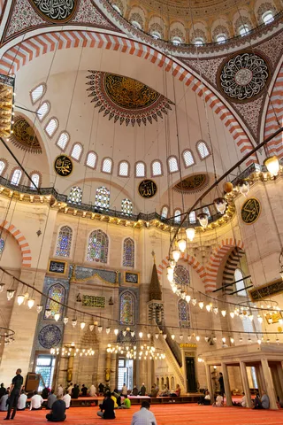 Worshippers beneath the chandeliers, Süleymaniye, Istanbul, Turkey — Nicolas Marincic