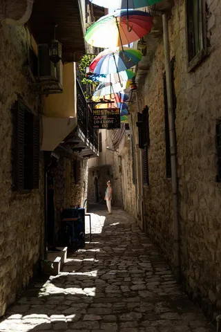 Cobbled alley beneath hanging umbrellas, Turkey — Nicolas Marincic