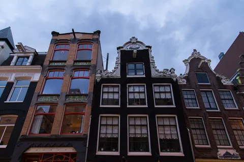 Row of gabled canal houses from below, Amsterdam, Netherlands — Nicolas Marincic