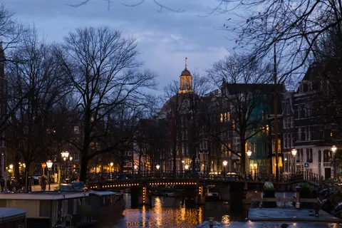 Canal bridge and lamps at dusk, Amsterdam, Netherlands — Nicolas Marincic