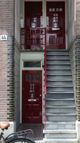Red doors and steep stoop staircase, Amsterdam, Netherlands — Nicolas Marincic