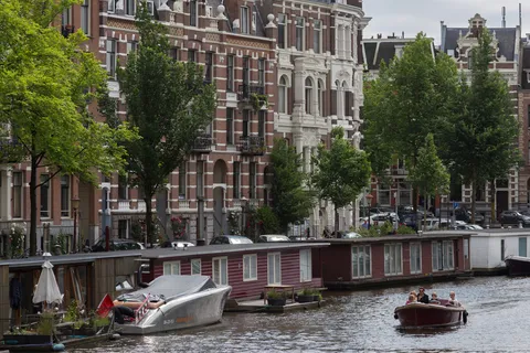 Canal with houseboats and boats, Amsterdam, Netherlands — Nicolas Marincic