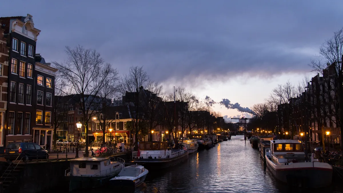 Boats moored on an Amsterdam canal at dusk, Netherlands — Nicolas Marincic
