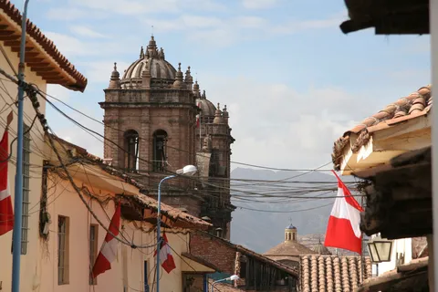 Church tower and Peruvian flags, Peru — Nicolas Marincic
