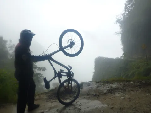 Cyclist in the fog on the Yungas Road, Bolivia — Nicolas Marincic