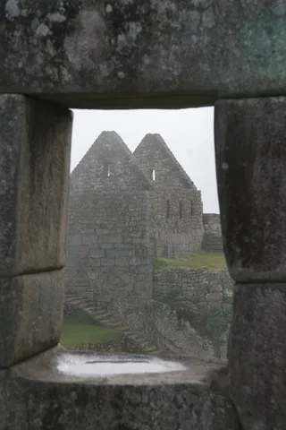 Trapezoidal window onto Inca houses, Machu Picchu, Peru — Nicolas Marincic
