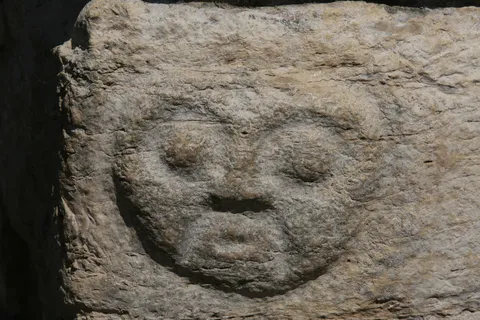 Carved stone face in the wall, Kuélap, Peru — Nicolas Marincic