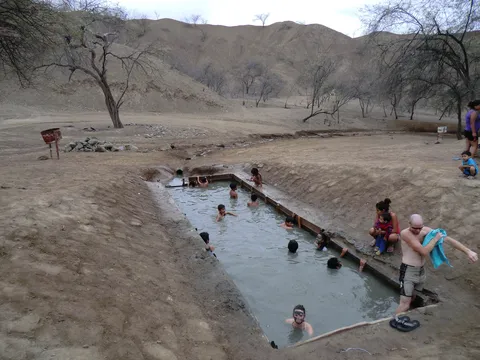 Bathers in a thermal pool in an arid valley, Peru — Nicolas Marincic
