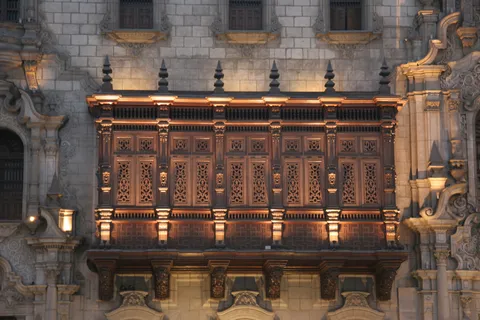 Illuminated wooden balcony of the Archbishop’s Palace, Lima, Peru — Nicolas Marincic
