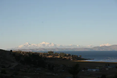 Cordillera Real at dusk across Lake Titicaca, Peru — Nicolas Marincic