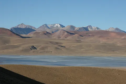 Salt lagoon and snow-dusted volcanoes, Sud Lípez, Bolivia — Nicolas Marincic
