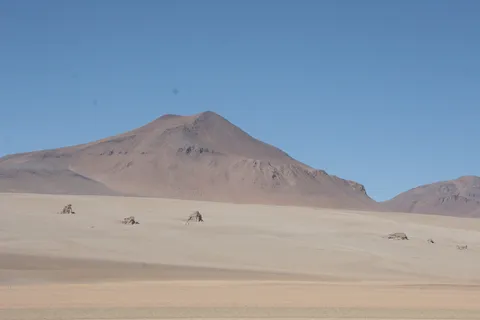 Scattered rocks below a volcano, Dalí Desert, Bolivia — Nicolas Marincic