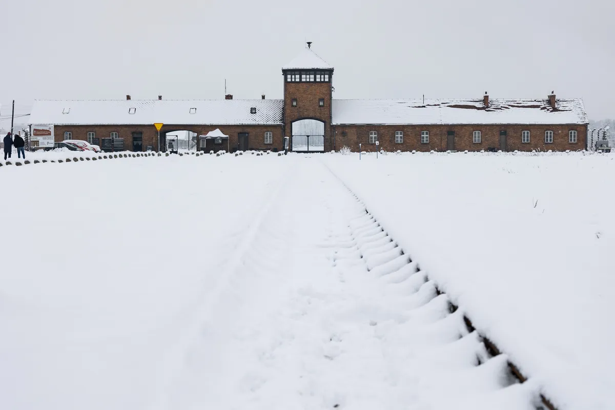 Snow-covered rails to the gatehouse, Auschwitz-Birkenau, Poland — Nicolas Marincic