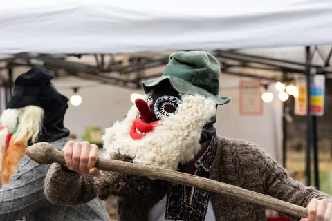 Fleece-masked figure at a winter festival, Romania — Nicolas Marincic